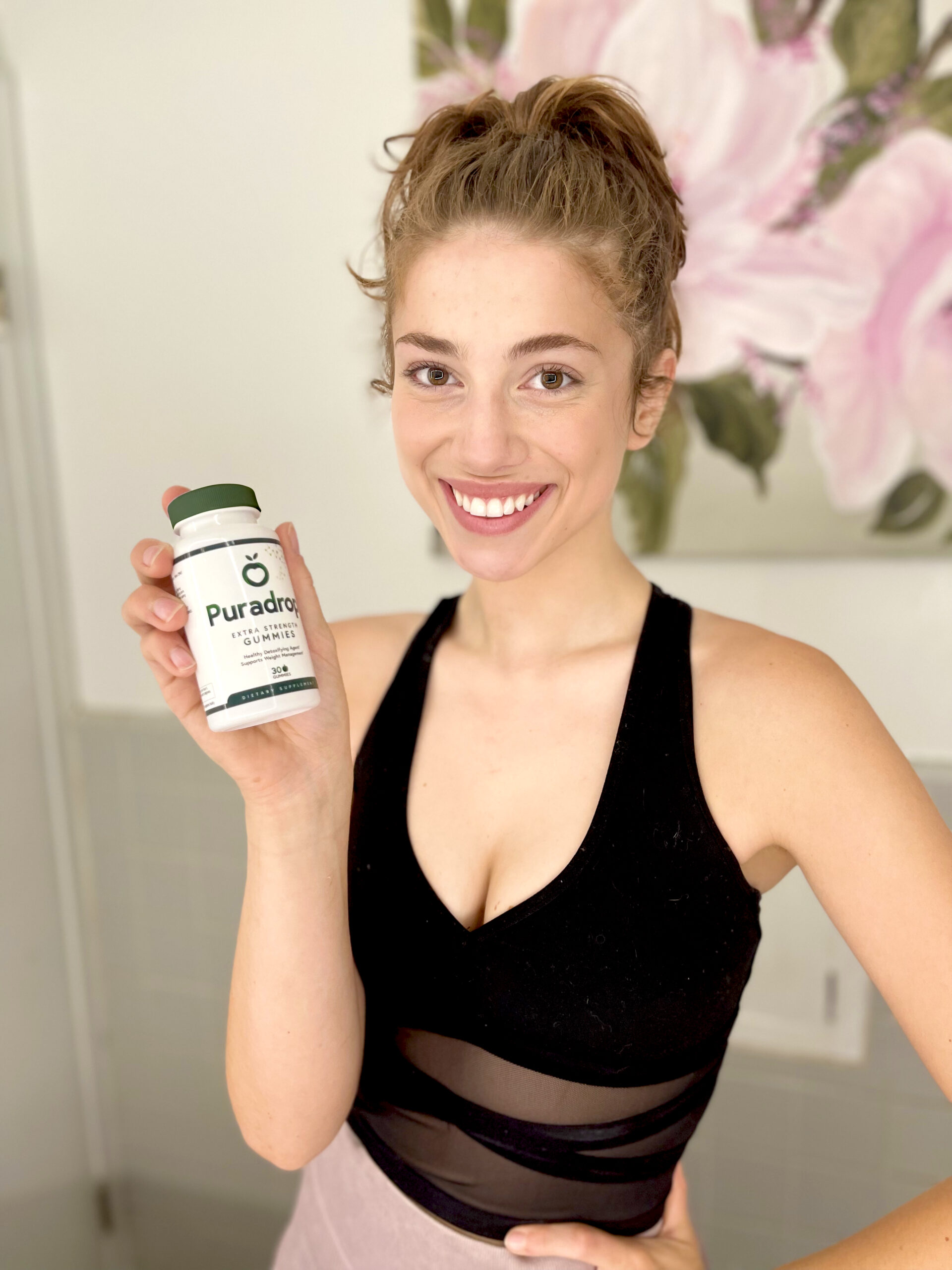 woman holding weight loss gummies