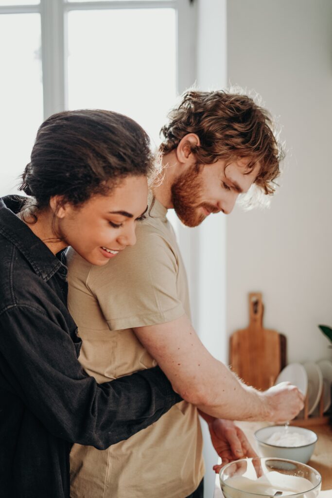 Love and Relationships people hugging in kitchen