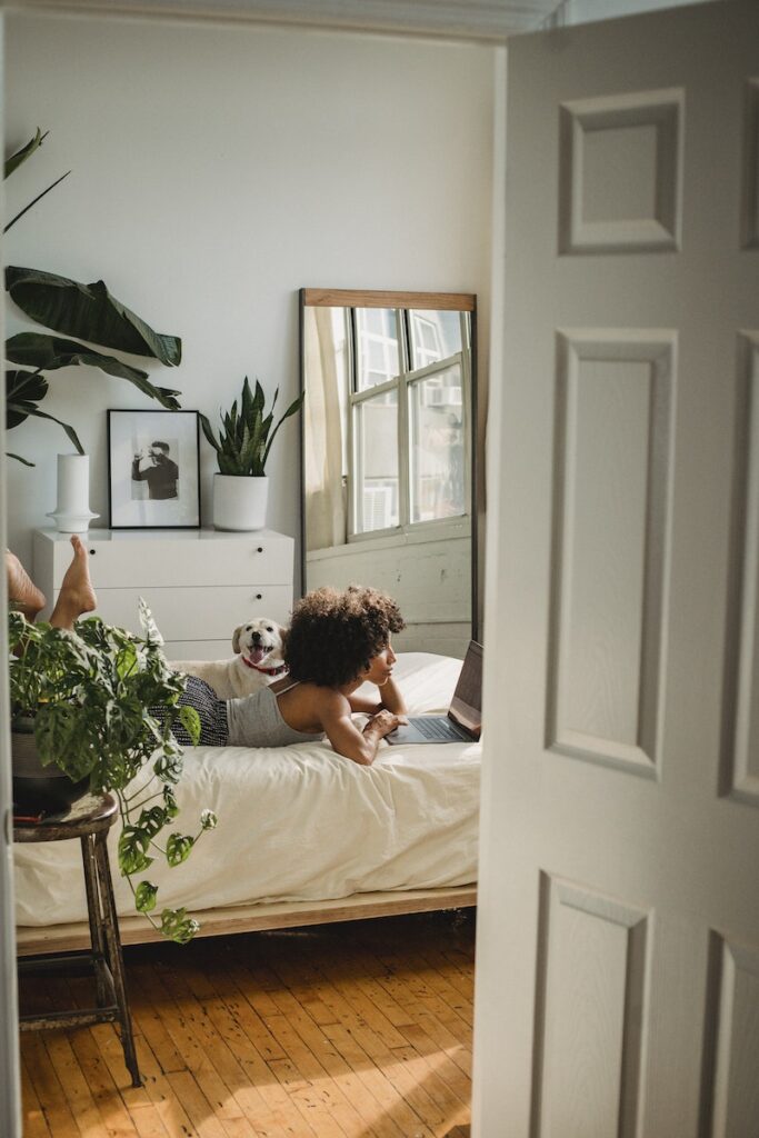 Woman with Dog in Cozy Bedroom