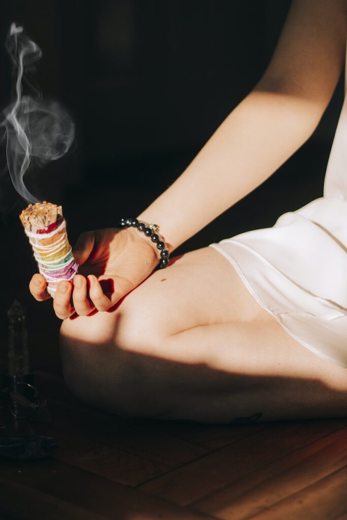Woman with smudge sticks on floor