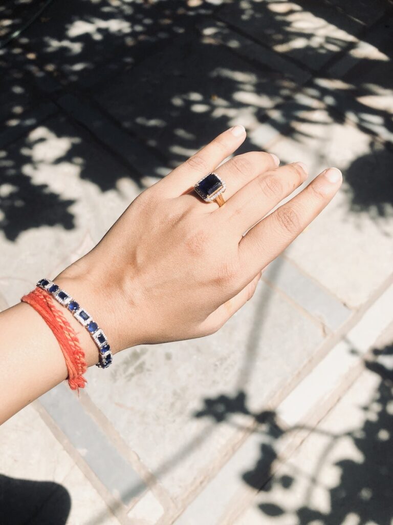 A Person Wearing Bracelets and a Ring with a Black Gemstone